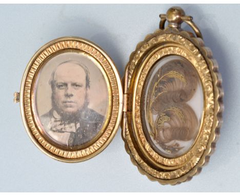 A Victorian yellow metal oval locket pendant, engraved throughout with foliate scrolls and engraved initials 'J & JR', the fr