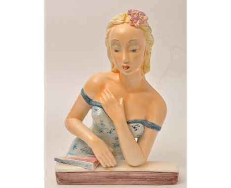 Figure of a young lady with low-cut dress, with blonde hair and pouting lips, leaning against a sill, 28.5cm approximately, i