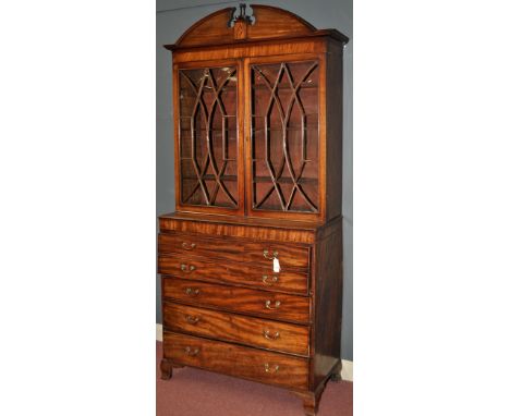 A George III mahogany secretaire bookcase, the broken arched pediment centred by turned finial and shell paterae, above a pai