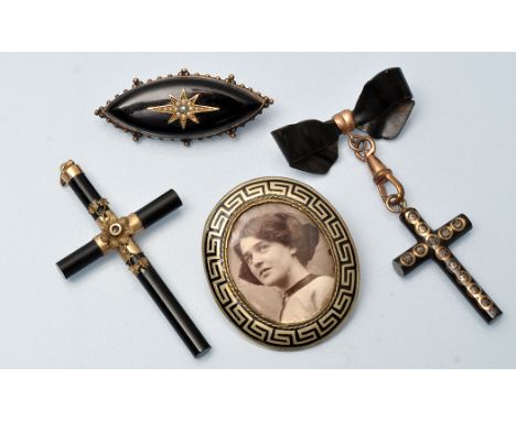 Victorian mourning jewellery, to include: an onyx and seed pearl star decorated brooch, of marquis form, within beadwork moun