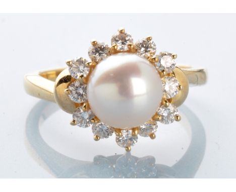 A cultured pearl and diamond cluster ring, the central cultured pearl measuring 8.5mm diameter, surrounded by twelve brillian