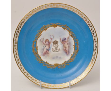 Sevres Bleu Celeste circular dish, central reserve panel painted with cherubs flanking crowned crowned cipher, signed "BRUNY"