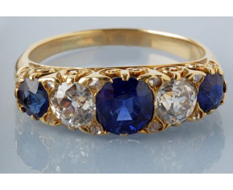 A sapphire and diamond ring, the central circular facet cut sapphire measuring 6 x 6 x 4mm, estimating to weigh approximately