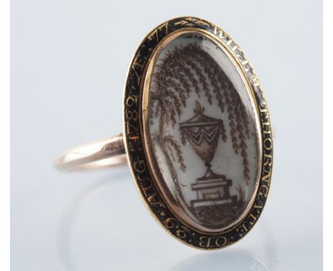 An 18th Century mourning ring, the central ivory plaque decorated with memorium urn under weeping willow, the black enamel be