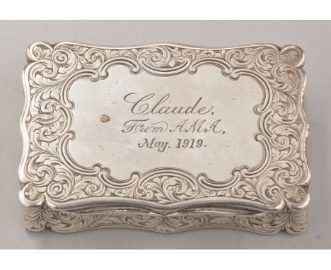 A Victorian silver snuff box, by Edward Smith, Birmingham 1850, shaped rectangular, with inscription and engraved foliated sc