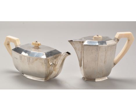 A George VI silver teapot and matching hot water jug, by Viners, Sheffield 1937 and 1938, each of Art Deco form, with ivory c
