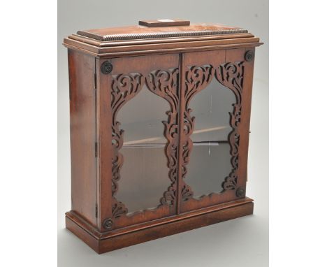 A 19th Century mahogany table top cabinet, the part reeded caddy-top above a glazed fret work panel door enclosing shelf, 36 