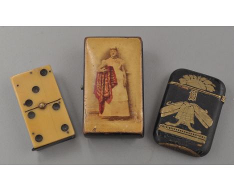 A Victorian papier mache snuff box, the cover with full-length photograph of a woman holding a rug, 6.5cms (2 1/2in.), a Vict