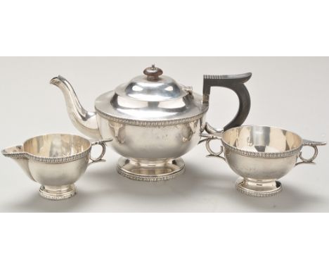 A George V three-piece silver tea service, by Walker & Hall, Sheffield 1914 and 1915, each piece circular with leafy band bor
