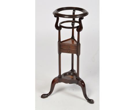 A George III style mahogany basin stand, the circular ring top on scrolling supports and turned uprights joined by two small 