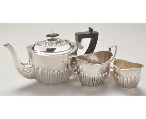 An Edwardian silver three-piece tea service, by William Thornywork, Birmingham 1901-02, each piece of oval half-fluted form, 