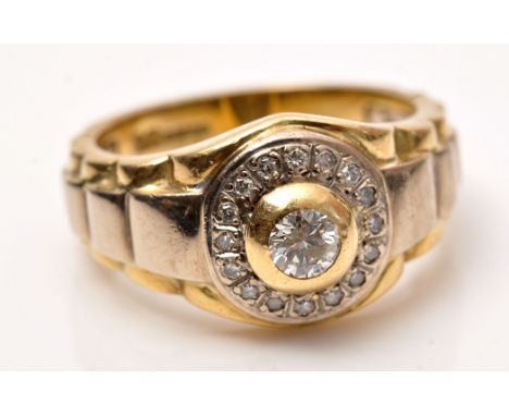 A gentleman's diamond ring, the central brilliant cut diamonds weighing approximately 0.25 carats surrounded by a bezel of ei