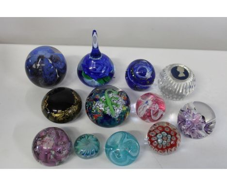 A shelf full of collectable paperweights 