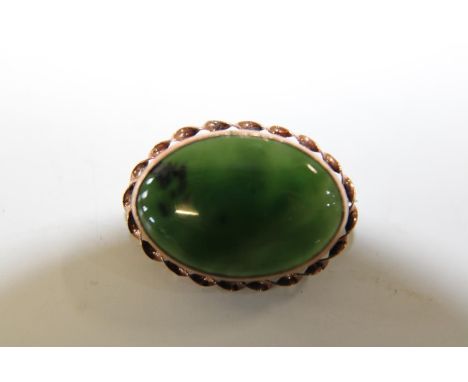 A 9ct gold brooch with green jade stone 