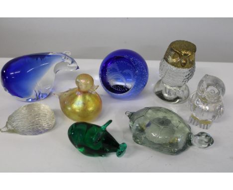 A shelf full of collectable paperweights 