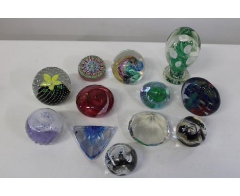 A shelf full of collectable paperweights 