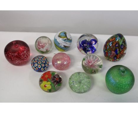 A shelf full of collectable paperweights 