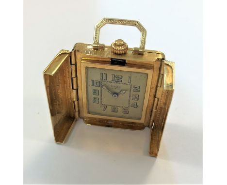 the body of square form resembling a handbag and decorated all over with polished symmetrical designs over an engine turned f