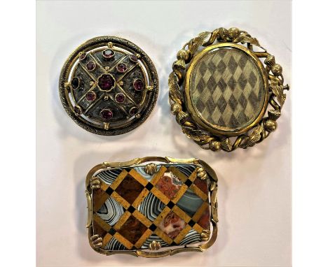 the first, of rectangular form and of chequerboard style with a mosaic of multi coloured hardstones, pierced mount, pin and h
