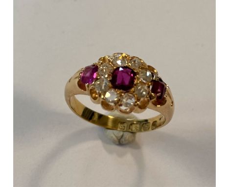 central claw set cushion shaped faceted ruby, estimated approximate weight 0.20ct, surrounded by eight claw set old cut diamo