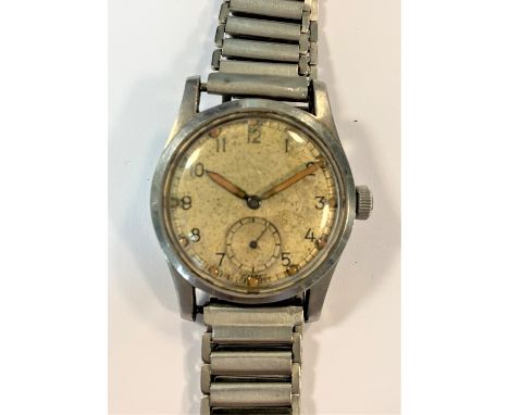 c1940, the cream coloured 'sterile' dial, 25mm diameter with black Arabic numerals, (originally) luminous hands and hour dots