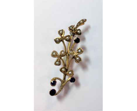 set with four round faceted sapphires and sixteen seed pearls, pin and hook fitting, additional jump ring fitting, length 4.1