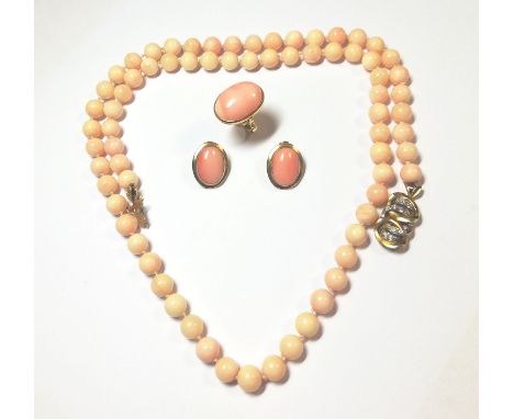 the first a single row of 8.5mm pale pink coral beads, strung to an ornate yellow metal clasp set with eight grain set round 