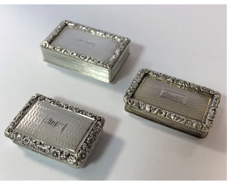 each of rectangular form with engine turned decoration all over, the piano hinged cover with an engraved central rectangular 
