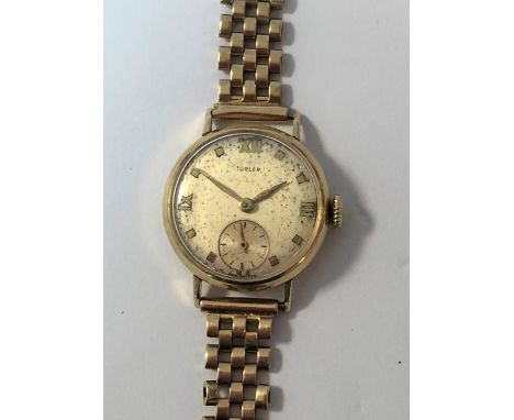 c1950, the signed silvered dial, 20mm diameter, with gold coloured batons and hands, quatre Roman numerals and subsidiary sec