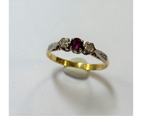 the central claw set round faceted ruby, estimated approximate weight 0.25ct flanked by two illusion set eight cut diamonds, 