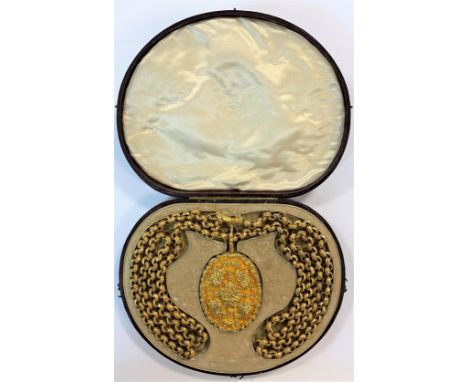 the large carved double hinged oval locket opens on one side to reveal a portrait of a smartly dressed gentleman within a gol