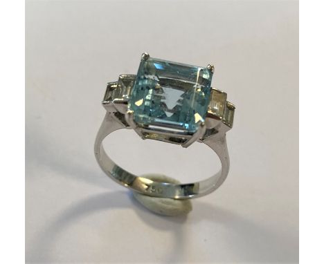 claw set square faceted aquamarine, estimated approximate weight 3.30ct, flanked by two graduating step down box set baguette