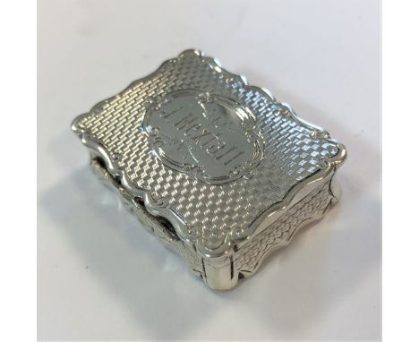 Birmingham 1871, of rectangular form, decorated all over with engine turned engraving, the piano hinged cover decorated to ma