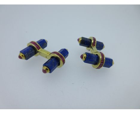 each end formed by a hexagonal lapis lazuli baton, the ends rubover set with a round cabochon ruby, each baton held by a band