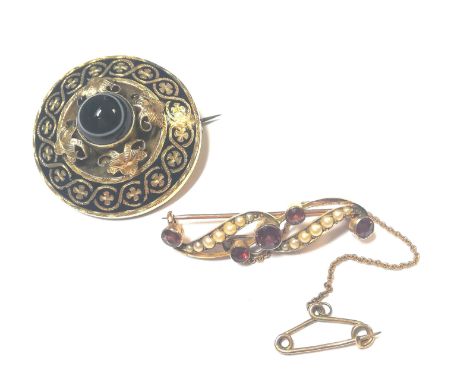 the first, of target style with a central round banded agate surrounded by foliate decoration at cardinal points and a black 