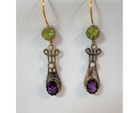 each hook wire fitting headed with a crimp set 5mm round faceted peridot, supporting a lyre shaped drop section, the wire wor