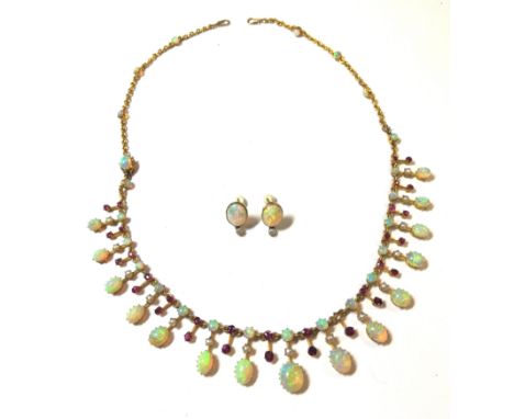 the necklace with central section set of alternate graduated opals and rubies, the round cabochon opals each with a seed pear