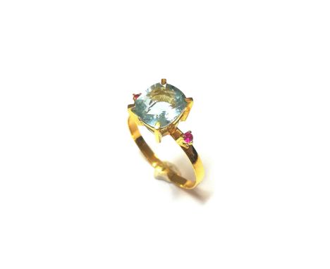 central cushion faceted aquamarine, estimated approximate weight 2.00ct, flanked by a claw set small round faceted ruby, full