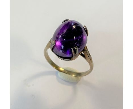 the oval cabochon amethyst, 14.6 x 11.4mm of a rich deep purple, with two eight cut diamonds in each tapered shoulder, 'D' sh