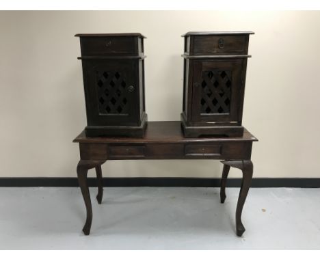 A contemporary hardwood two-drawer console table together with a pair of bedside cabinets with lattice doors