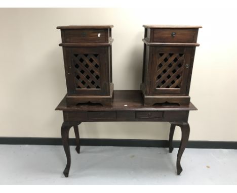 A contemporary hardwood two-drawer console table together with a pair of bedside cabinets with lattice doors