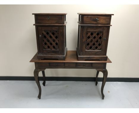 A contemporary hardwood two-drawer console table together with a pair of bedside cabinets with lattice doors