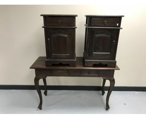 A contemporary hardwood two-drawer console table together with a pair of bedside cabinets with panel doors