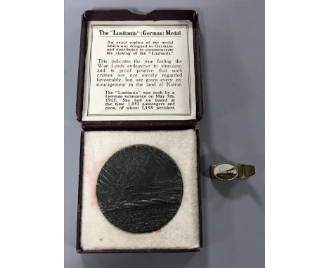 An R M S Lusitania medal, boxed with paperwork together with a Titanic brooch (2)
