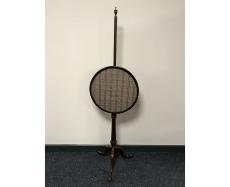A mahogany pole screen on tripod support