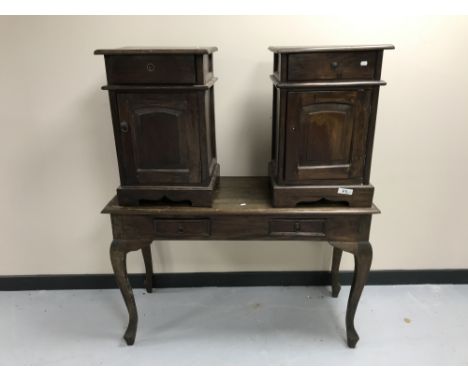 A contemporary hardwood two-drawer console table together with a pair of bedside cabinets with panel doors