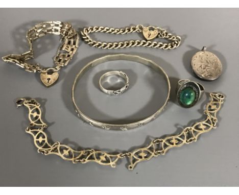 Two silver padlock bracelets, a silver locket, a bangle, two white metal rings and similar bracelet