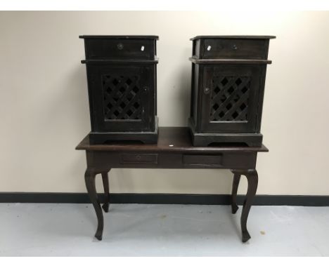 A contemporary hardwood two-drawer console table together with a pair of bedside cabinets with lattice doors