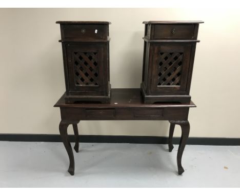 A contemporary hardwood two-drawer console table together with a pair of bedside cabinets with lattice doors