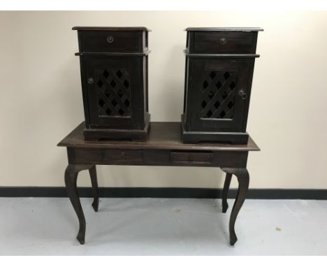 A contemporary hardwood two-drawer console table together with a pair of bedside cabinets with lattice doors